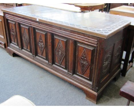 A large 18th century oak coffer with later converted front panel, on bracket feet, 188cm wide.