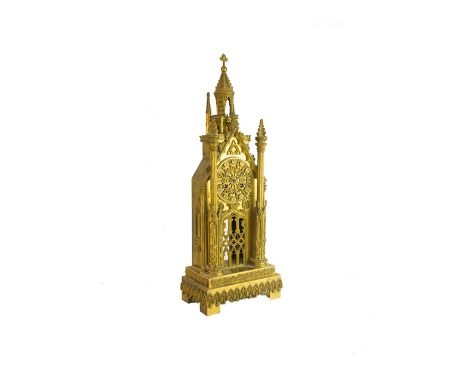 A Victorian gilt brass mantel clock of Gothic Cathedral form, with central tower over an ornate dial and pierced pendulum ape