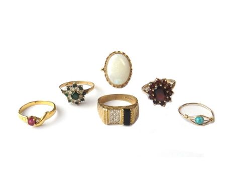 A 9ct gold ring mounted with a large oval opal, a 9ct gold, black onyx and diamond set ring, a 9ct gold, green and colourless