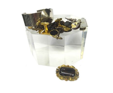 A silver wide bangle, with a disc motif, weight 97.5 gms, a silver and mother of pearl folding fruit knife cum button hook, S