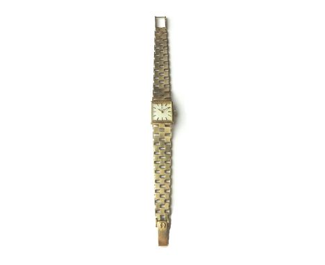 A ladies 9ct gold Omega bracelet wristwatch, the signed square silvered dial with black baton shaped numerals, on a tapering 