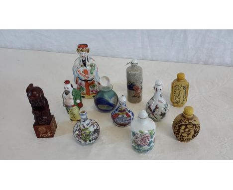 A collection of ceramic oriental scent bottles, hard stone carved token figure & ceramic figure.