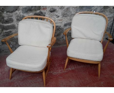 2 ercol blonde arm chairs with material cushions 