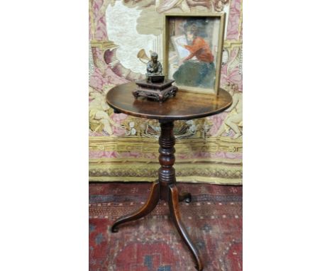 A George III oak tripod occasional table, circular top, tilting on ring turned column, scroll legs, 71cm high, 48cm diam, c.1