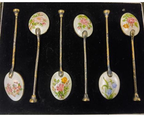 A set of six silver and enamel coffee spoons, the backs with wild flowers, cased 