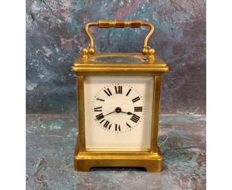 A 20th century brass carriage clock, Roman numerals, swing handle, 10cm high 