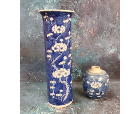 A Chinese cylindrical vase, decorated with prunus blossom on a blue ground, 30.5cm high, Kangxi double concentric marks but l