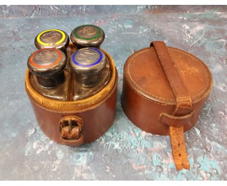 A set of four Edwardian silver and and enamelled travelling cologne bottles, each with coloured enamelled band and initials, 