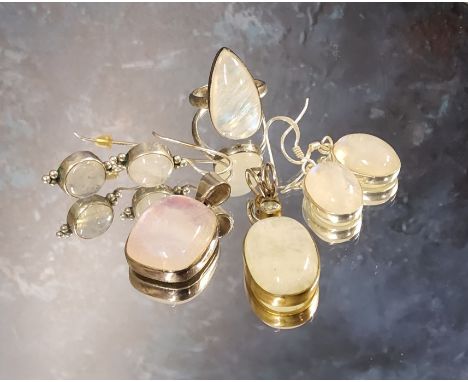 A silver gilt mounted moonstone drop pendant, the oval moonstone surmounted with a collet set round white stone; another silv