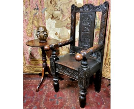 A late 17th century and later English oak Wainscot type country house hall chair, profusely carved throughout with foliate sc