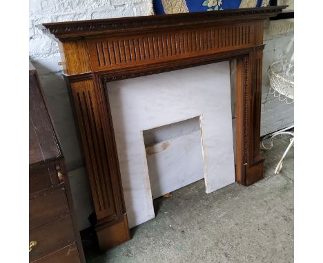 A contemporary mahogany and marble fire surround 