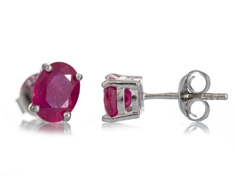 PAIR OF TREATED RUBY STUD EARRINGS set with oval stones, in silver