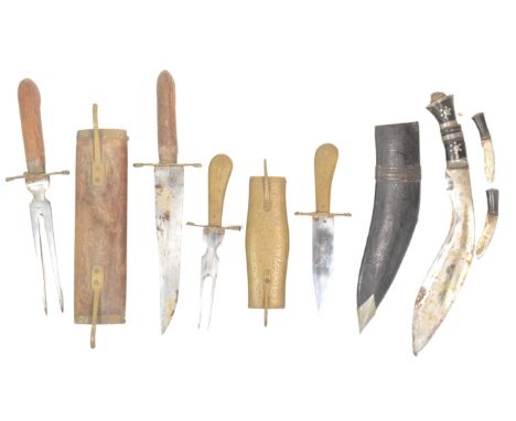 An Indian made Nepalese Kukri knife dagger with smaller Karda and Chakmak knives together with two Indian fish knife sets. On