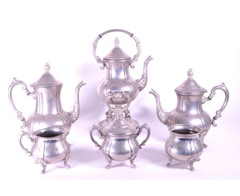 A Victorian style spirit Kettle on tilting stand together with x2 other kettles, sugar bowls and milk pourers. Label on the t
