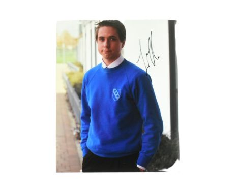 The Inbetweeners - Joe Thomas (Simon) - autographed 8x10" colour photograph from the series. Signed in black ink to a light p