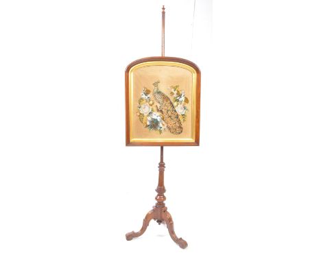 A 19th century Victorian walnut pole screen. The pole screen with needlepoint tapestry having carpet peacock with glass eye a