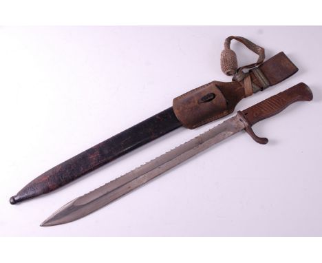 A German M98/05 Pioneer bayonet, having a 36.5cm saw back with hooked quillon, two piece walnut grips and flash guard, housed