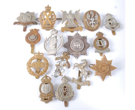 A collection of cap badges and insignia to include Duke of Lancaster's Own, The West Riding, 2nd Dragoons (The Bays), 3rd Kin