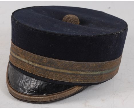 A Victorian Officer's pillar box hat, in blue cloth with gilt banding and black leather peak, housed in a brown leather hat b