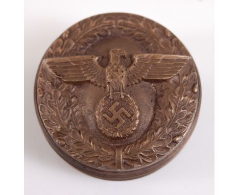 A German snuff-box of circular form, the cover relief decorated with an eagle and swastika within wreath, 5cm.
