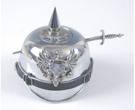 An early 20th century silver plated novelty inkwell in the form of a Prussian pickelhaube, h.7cm.