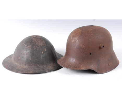 A British Army M1916 Brodie helmet, together with a German M1916 steel helmet. (both lacking liners.) (2)