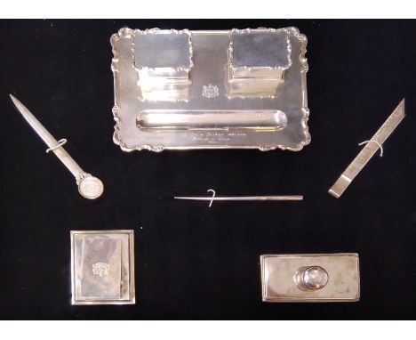 A large cased Indian silver desk set, comprising pen tray with integral inkstands, letter-opener, blotter, rule, card clip an