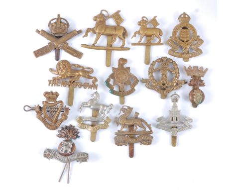 A collection of cap badges and insignia to include Royal Dublin Fusiliers, Loyal North Lancashire, Royal Army Ordnance Corps,