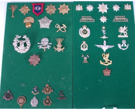 A collection of British Army cap badges and insignia to include Gordon Highlanders, 17th/21st Lancers, Welsh Guards and Artic