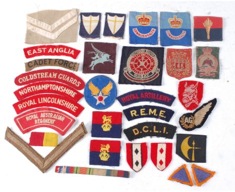 A collection of cloth formation signs, shoulder titles, lapel badges and buttons to include Airborne Division, East Anglain D