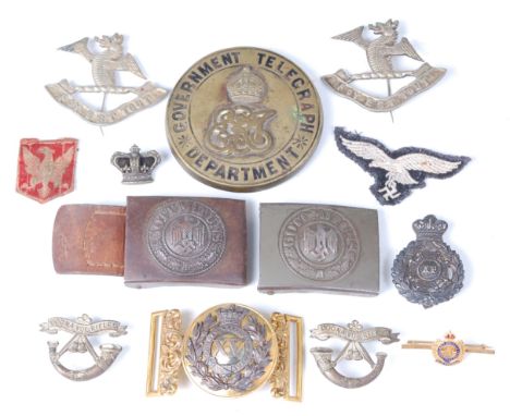 A German Third Reich Army belt buckle with brown leather tab, together with one other similar buckle, a Royal Engineers gilt 