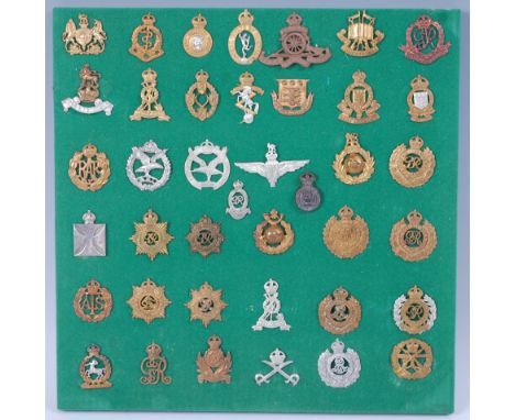 A collection of cap badges and insignia to include Royal Army Pay Corps, Royal Artillery, Royal Engineers, Intelligence Corps