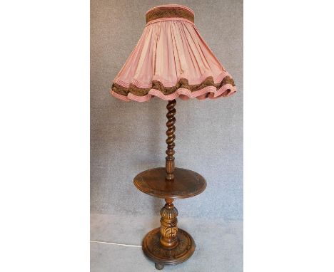 A vintage oak lamp standard with barleytwist column on circular carved base. H.73cm 