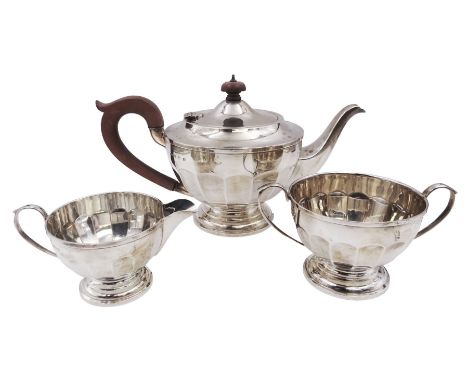 1920s three-piece silver tea service, comprising teapot with Bakelite handle and finial, milk jug and twin handled open sucri