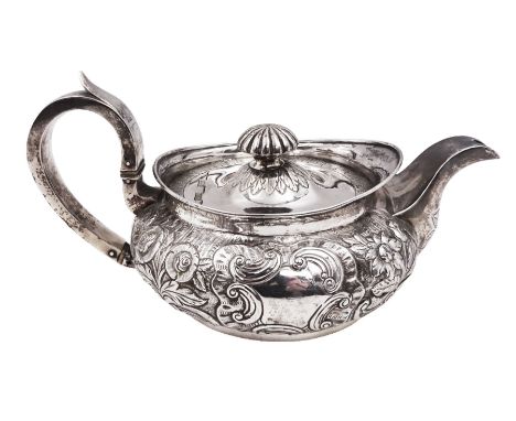 George III Irish silver teapot, of squat circular form, the body with repousse and chased floral and C scroll decoration, wit