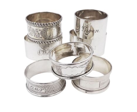 Seven silver napkin rings, of varying design, including examples with engine turned and engraved decoration, all hallmarked w