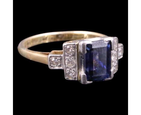 A fine and striking 1940s Art Deco influenced sapphire and diamond ring, comprising an emerald cut sapphire of approx 1.7 ct,