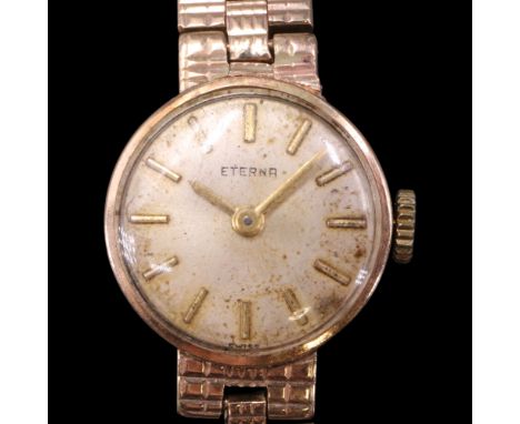 A vintage lady's Eterna 9 ct gold wristwatch, having a radially brushed champagne face with gilt baton markers and pencil han