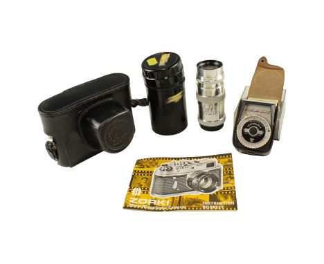 A Soviet Zorki-4K SLR camera with two lenses, a manual and a Leningrad 4 light meter