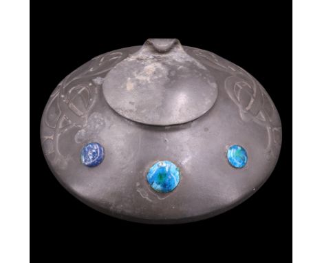 Archibald Knox for Liberty, a Tudric enamelled pewter inkwell, of shallow domed form with hinged lid, relief-decorated with p