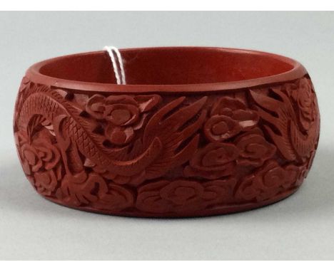 CHINESE CINNABAR LACQUER BANGLE,with incised dragon designs, 8cm diameter