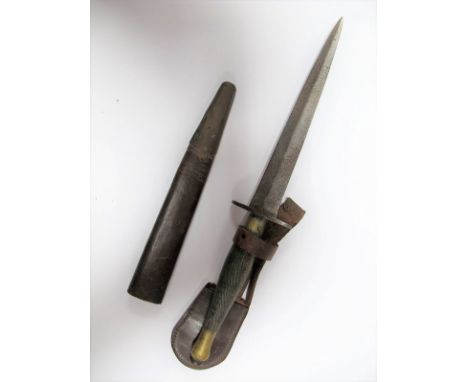 A Fairburn Sykes WWII Fighting Commando Dagger, brass hilt some rusting to blade, leather scabbard, damaged. 