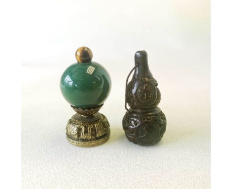 A Chinese mandarin hat style bronze and stone decoration, H. 6.5cm together with a gourd shaped amulet. Prov Jean Rich collec