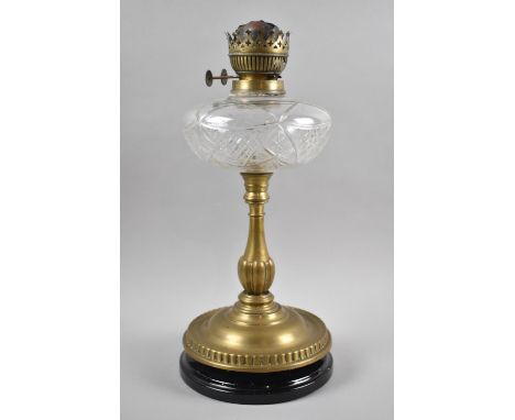 A Late Victorian Brass Oil Lamp with Cut Glass Reservoir and Ebonised Circular Base, 41cm high 