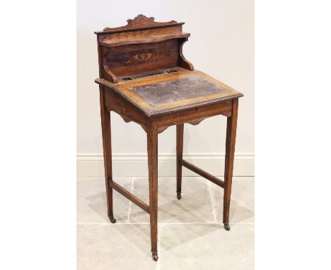 A late 19th century ladies rosewood writing desk, the raised back with a serpentine shelf and foliate inlay above a pen tray 