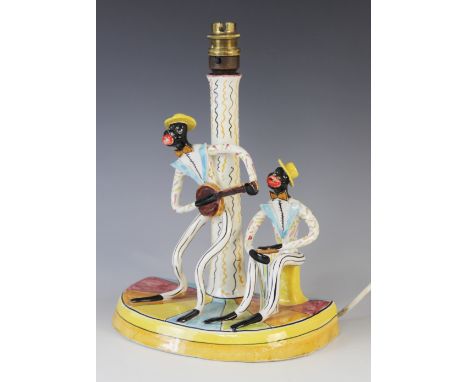 A Italian jazz band table lamp base, mid 20th century, modelled as a banjo player and a bongo player, set to a semi-circular 