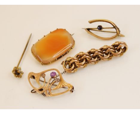 A yellow metal amethyst set Art Nouveau brooch, in the manner of Archibald Knox for Liberty, 3.7cm wide (at fault), together 