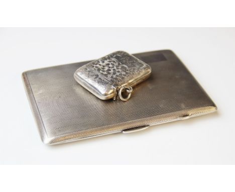 A George V silver cigarette case by E.J. Houlston, Birmingham 1919, of rectangular form with engine turned decoration and vac