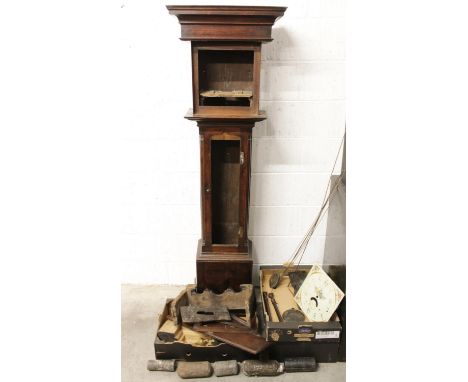 A collection of longcase clock parts, to include; an oak case, five weights, painted dial, pendulums and rods, clock case par