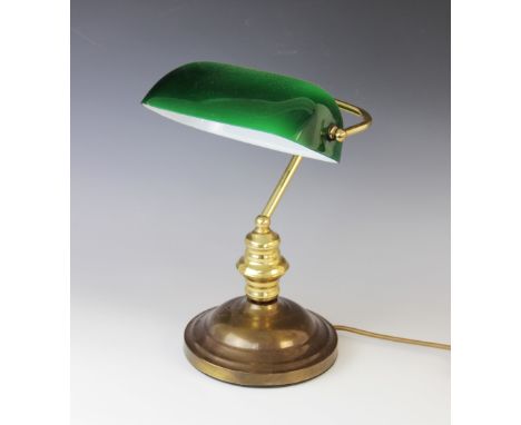 An Art Deco desk lamp, early 20th century, of typical form with brass frame and green shade, 37cm high Lighting lots are sold